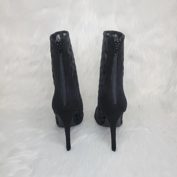 Pointed toe black mesh stiletto heeled ankle boots.