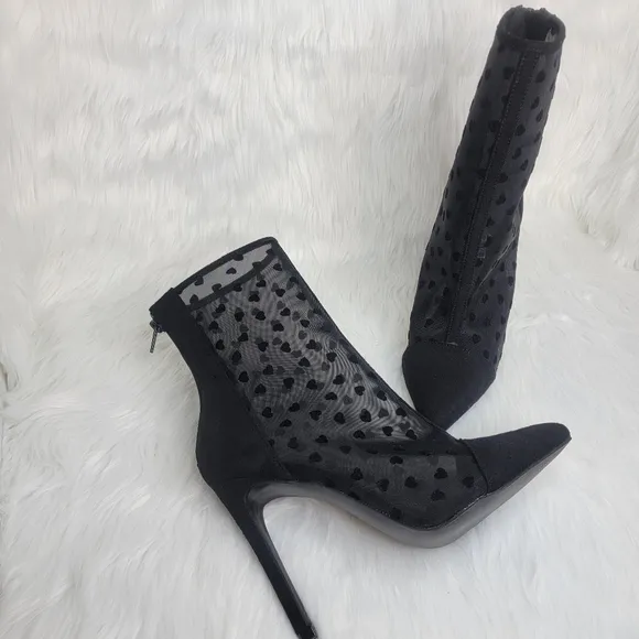 Pointed toe black mesh stiletto heeled ankle boots.